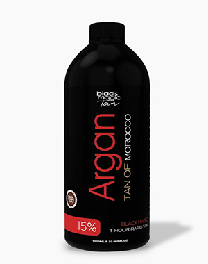 A black bottle of Black Magic Tan's Argan oil-infused tanning solution, with "Argan" and "Tan of Morocco" written in red on the label. "15%" and "1 HOUR RAPID TAN" are written at the bottom of the bottle.