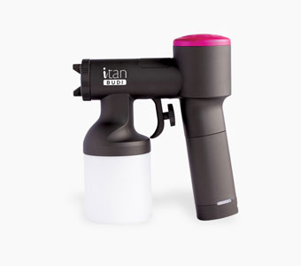 A handheld spray tanning device, primarily black with a pink accent on top, featuring "iTan BUDI" written on the side and a white solution cup attached underneath.