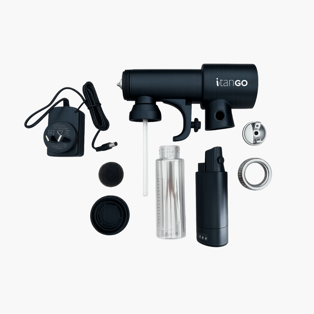 iTan GO portable cordless spray tan gun with charger, solution bottle, foam filter, spray components and accessories on white background
